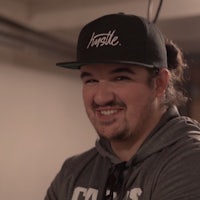 a man wearing a hat and smiling