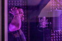 a man in a recording studio with headphones on